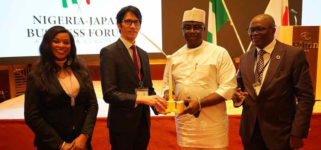 Akio Hashimura presenting Hon. Minister Of State Budget And National Planning of Nigeria a model of the Raijin Float